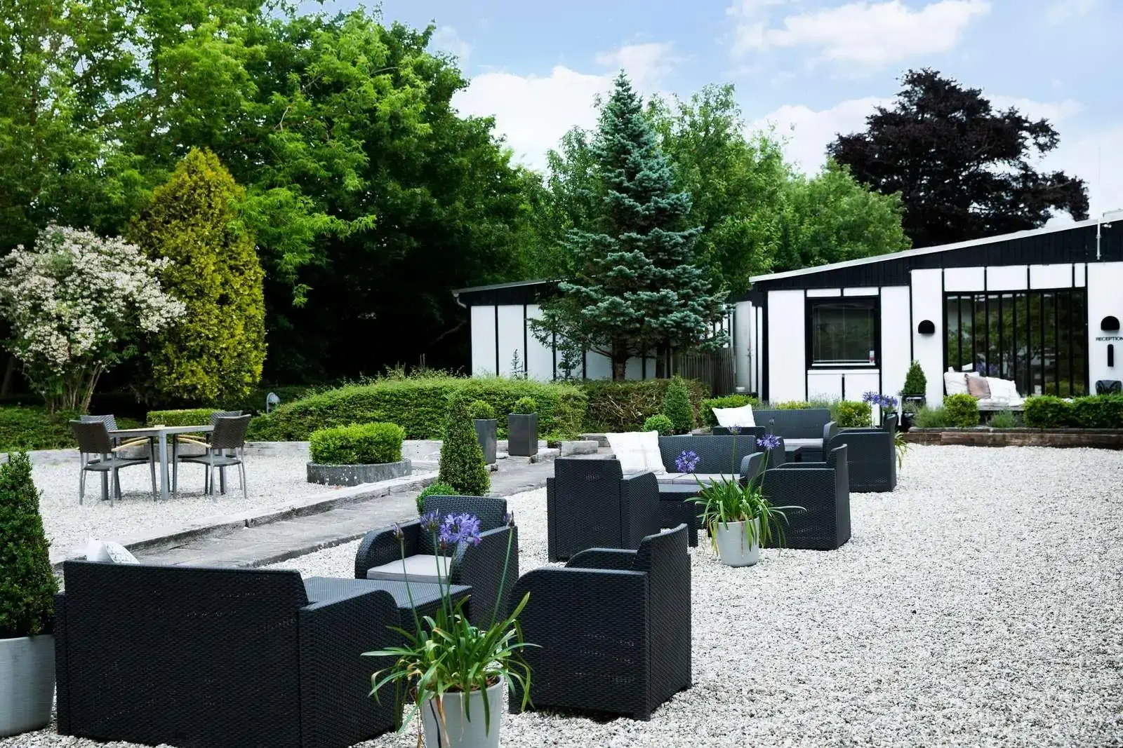 Patio of a hotel with modern garden furniture in a monochrome colour scheme
