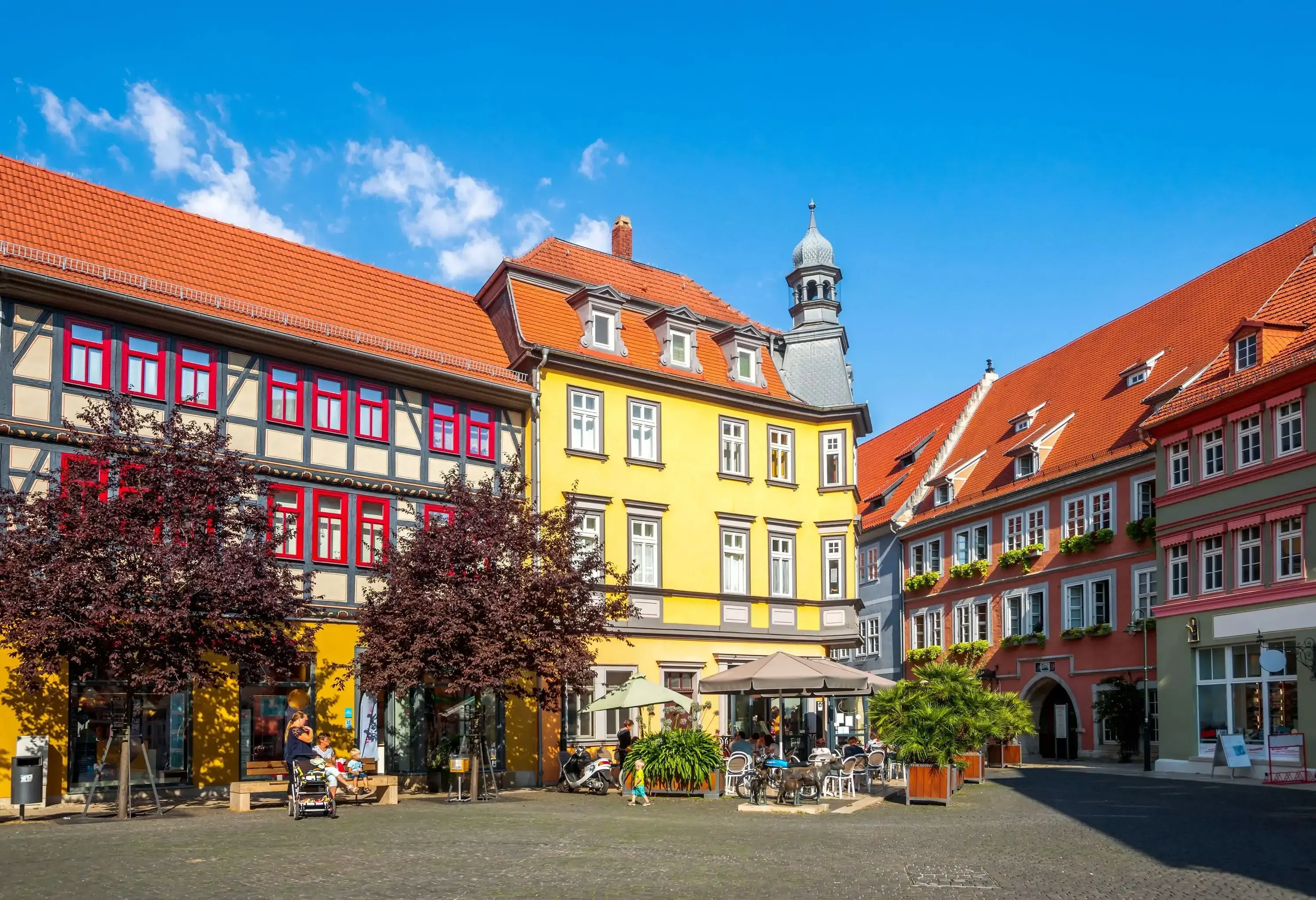 A charming town plaza surrounded by colourful architecture and outdoor cafes.