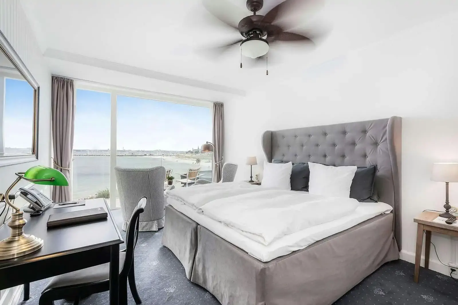 Cozy nordic style hotel room with large windows and sea view