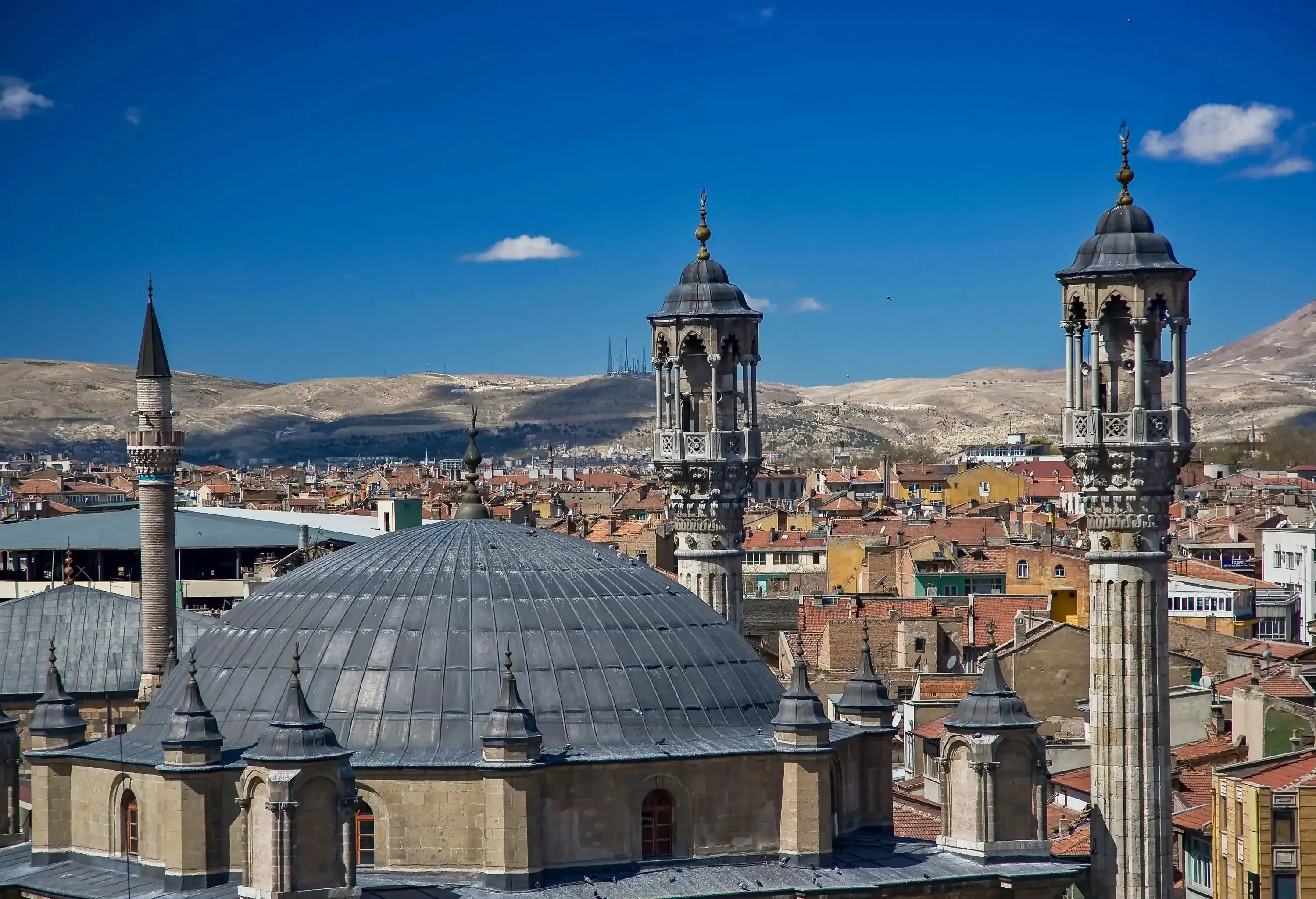 The dome and minarets of Aziziye Mosque towering over the city buildings.