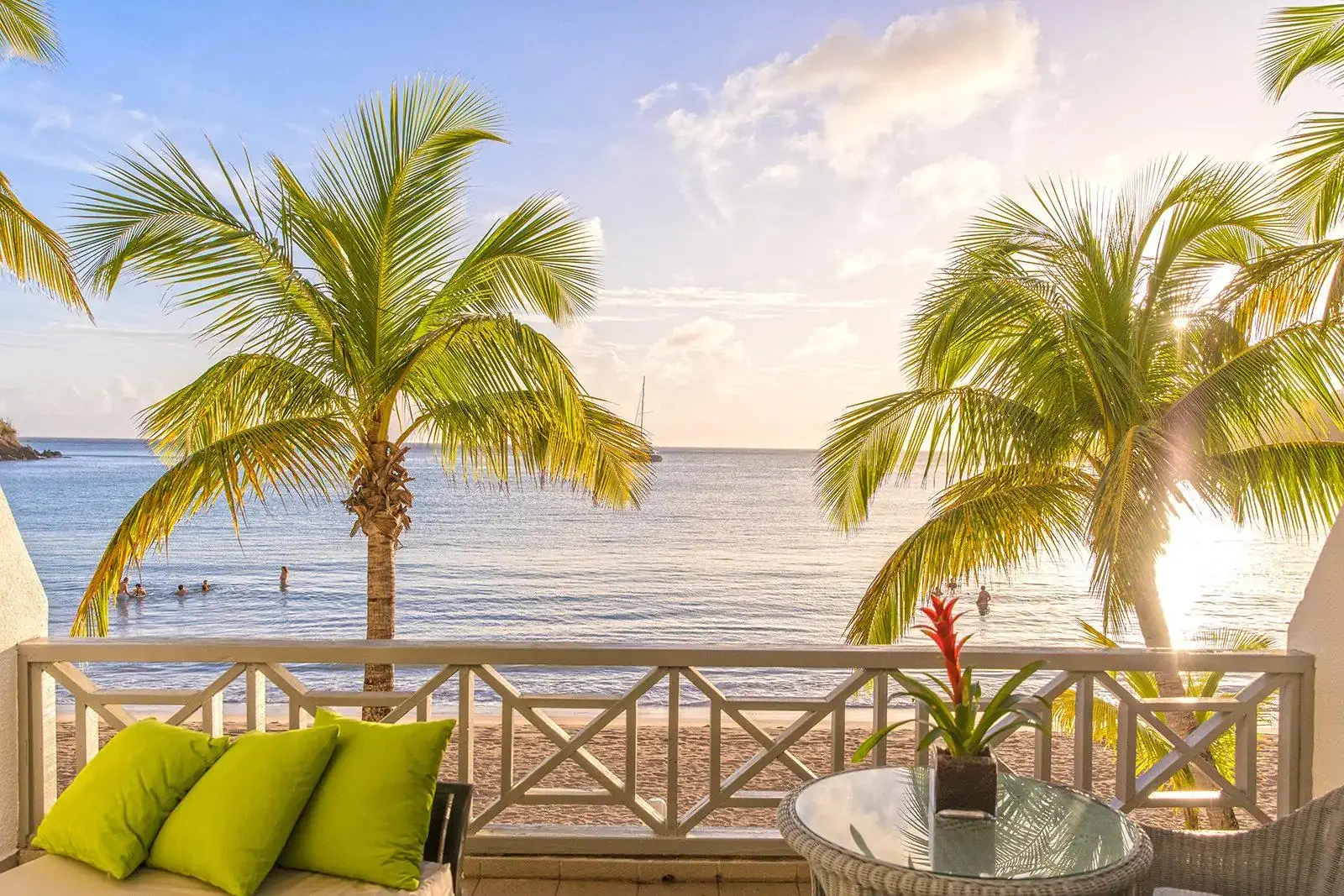 View from a terrace of a beach with palm trees in the early morning