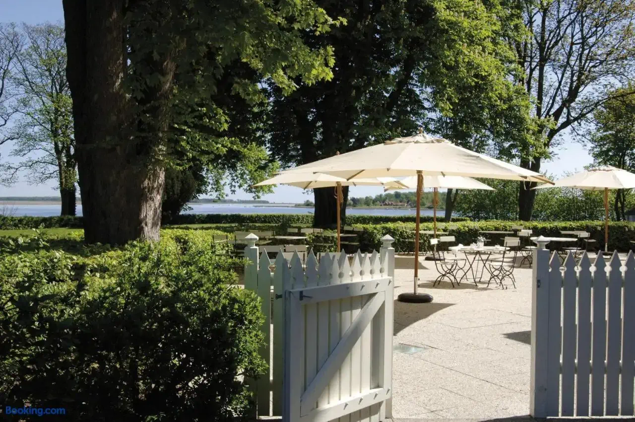 View from a sundeck towards a green lawn with sea view