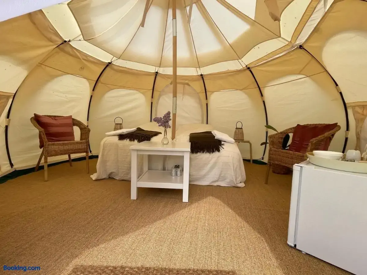 Interior of a glamping tent furnished in bohemian style
