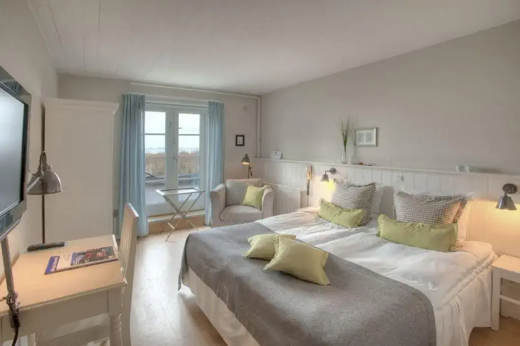 A hotel room in pastel colours decorated in modern country style