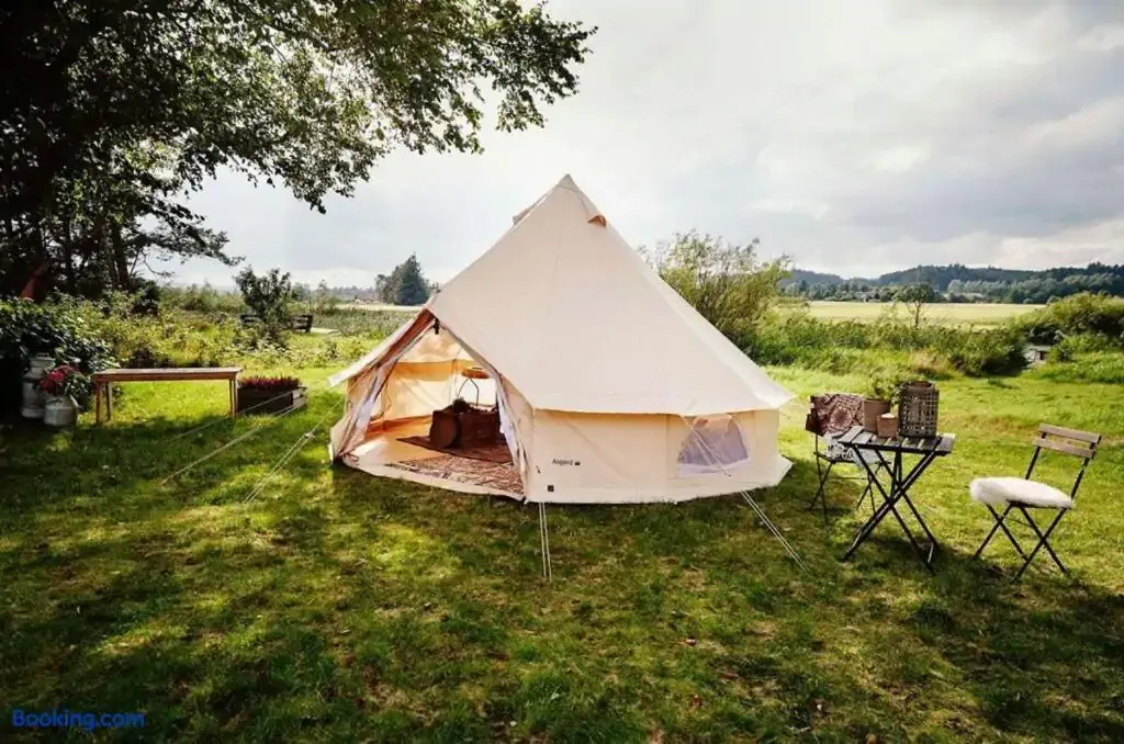 A glamping tent in a field on a sunny day