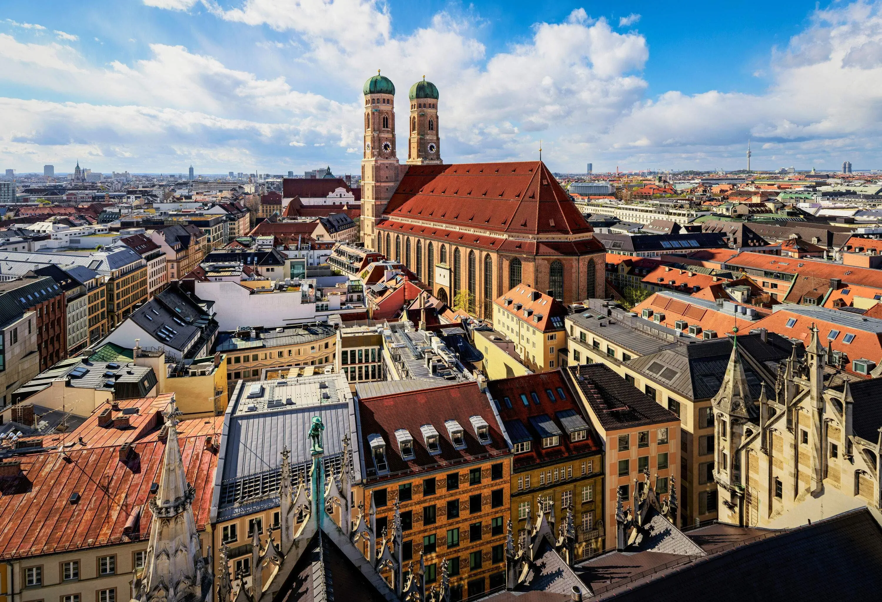 Among the gorgeous cityscape of buildings stands a cathedral with two frontal domes.