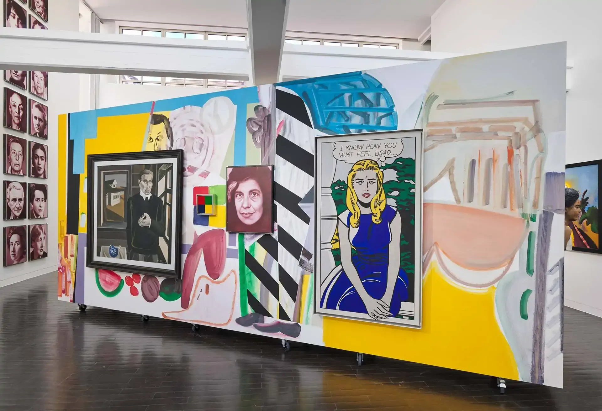 A wall filled with colorful paintings divides the room: classic portraits, pop art, abstract shapes, and geometric figures all clash and complement one another.
